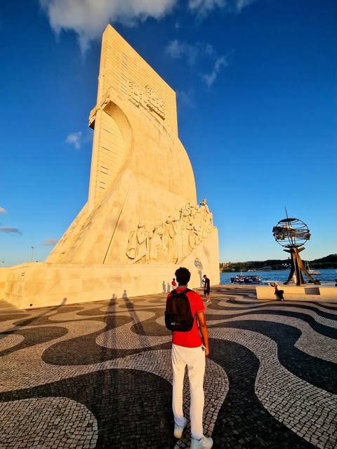 Jonathan beside a sculpted stone monument